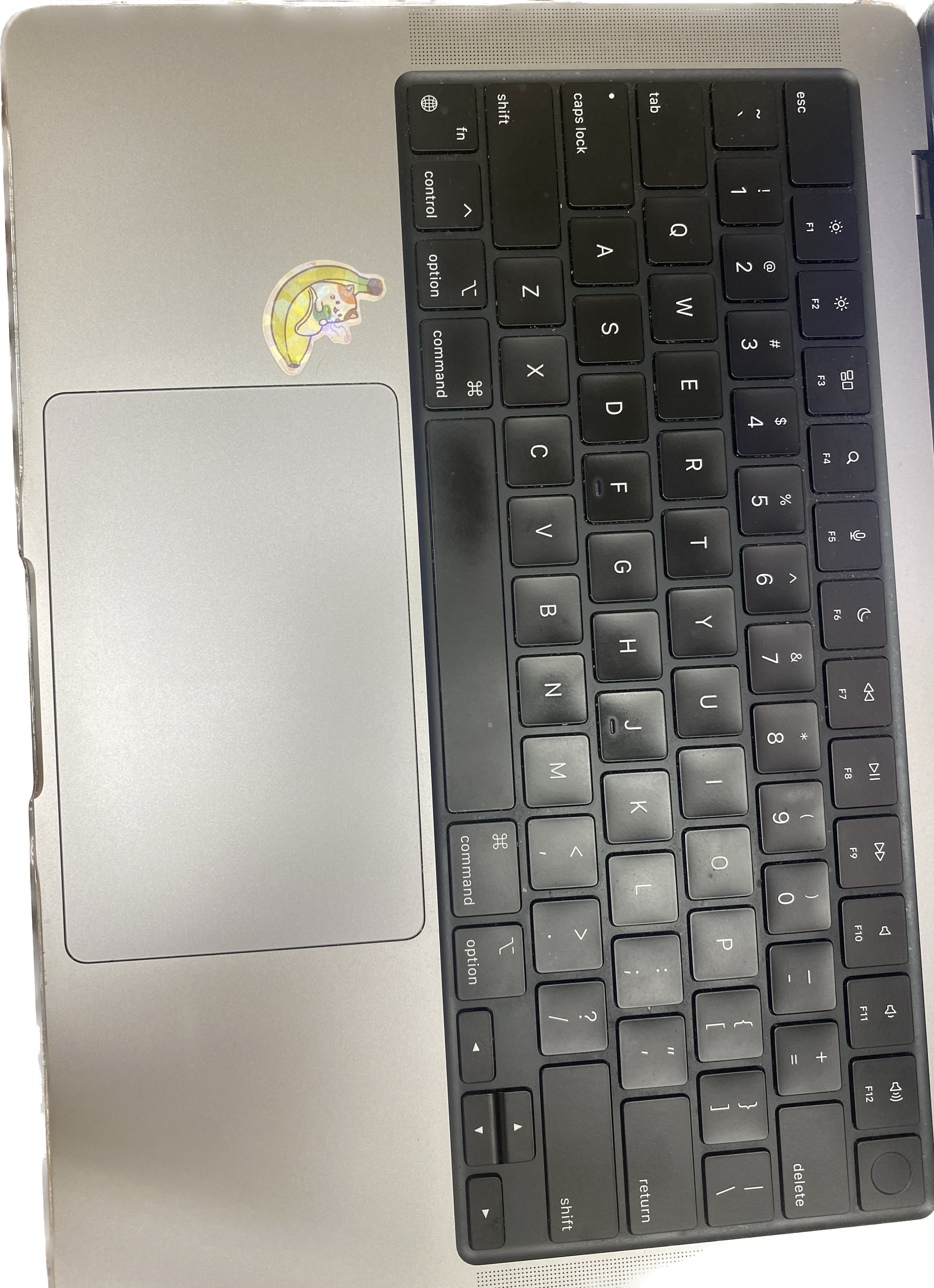  keyboard with a sticker near the mousepad